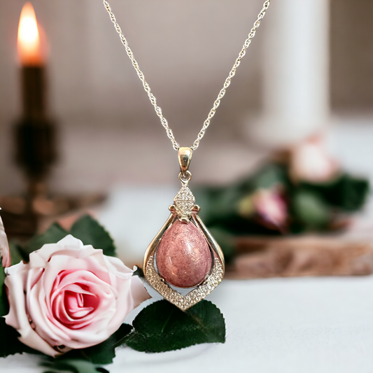 Close-up view of Crystal Drop sterling silver necklace with a pear-shaped pink cremation stone, highlighting the delicate beauty and emotional significance of the piece for remembering loved ones.