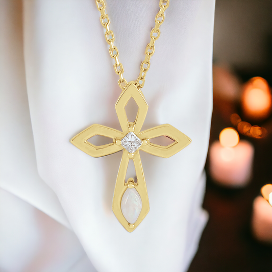 14k gold cross necklace with a central diamond and opal, illuminated against a soft background, symbolizing a radiant display of faith.