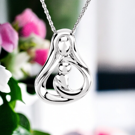 Sterling silver necklace with a mother and  one child embrace pendant hanging against a soft background, reflecting the light of unconditional love.