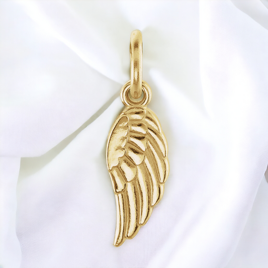 14k gold angel wing charm showcasing its finely crafted texture and warm glow, symbolizing everlasting love and protection.