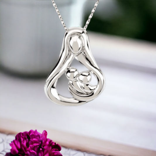 Gleaming mother's embrace pendant with 2 children in sterling silver, suspended on a chain, set against a vibrant floral backdrop, symbolizing a mother's nurturing spirit.