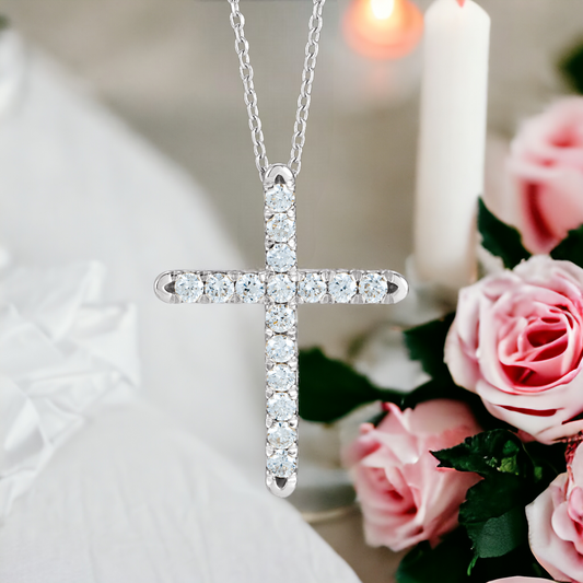 Silver diamond cross necklace against a backdrop of roses and candles, reflecting a serene and holy ambiance.