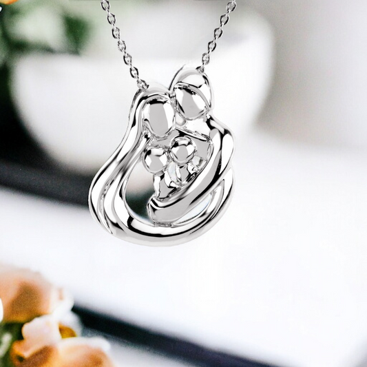 Sleek family embrace necklace in sterling silver, showcasing a glossy two-children design with a reflective finish, symbolizing a loving family bond.