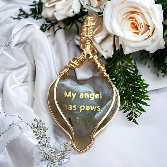The gold quote on the back of the necklace reads "My angel has paws." Labradorite heart-shaped natural gemstone with flashes of blue in a 14K Gold-Filled setting with gold angel wing paw-print design on the front.