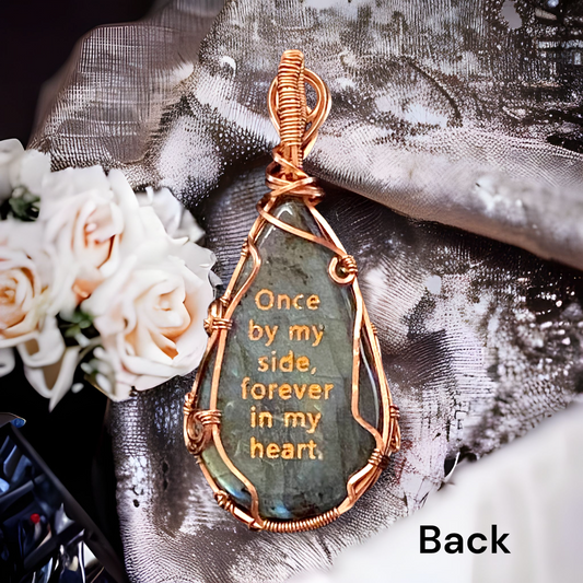 Copper quote on back: "Once by my side, forever in my heart."  Labradorite teardrop shaped natural gemstone with flashes of blue Pure Copper setting.  Copper angel wing paw print design on front.