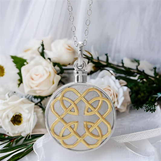 This Celtic knot cremation ash necklace for women is the perfect keepsake to remember a pet or loved one. Sterling Silver round pendant with 14K gold plated design.