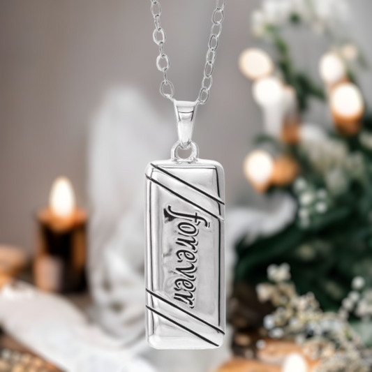 This lovely Forever cremation ash necklace for women is the perfect keepsake to remember a pet or loved one. A vertical rectangle shaped ash urn.  Antiqued "Forever" design on the front. Sterling Silver pendant.