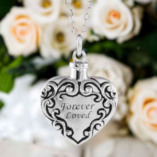 This beautiful forever loved heart cremation ash necklace for women is the perfect keepsake to remember a pet or loved one. Antiqued filigree heart design in Sterling Silver. The words "Forever Loved" are center on front. Option to engrave the back.  