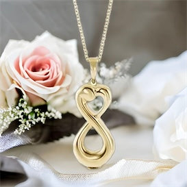 This beautiful infinity inspired cremation ash necklace for women is the perfect keepsake to remember a pet or loved one. Vertical infinity inspired shaped urn pendant.  Choice of Sterling Silver or 3 colors of 10K Gold. 