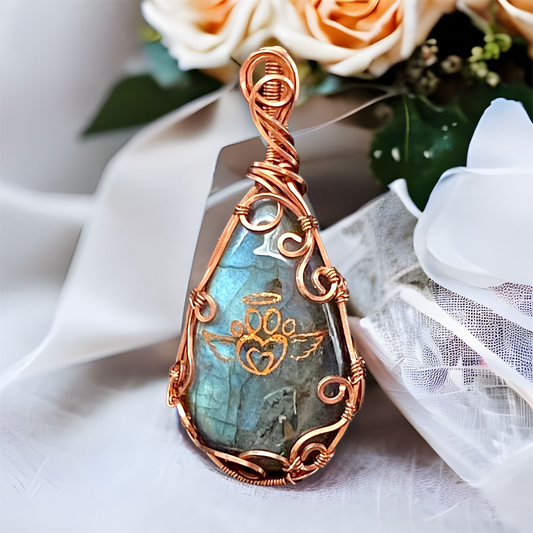 Labradorite teardrop shaped natural gemstone with flashes of blue Pure Copper setting.  Copper angel wing paw print design on front.