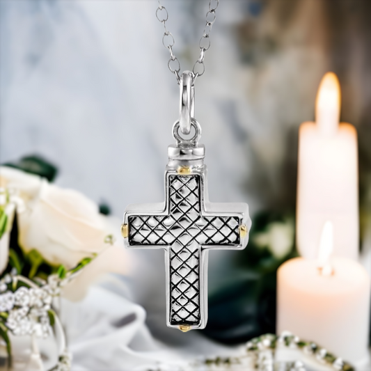 This lovely cross cremation ash necklace for women is the perfect keepsake to remember a pet or loved one.  Antiqued woven design on front of cross. Gold Plated accents on the sides. Sterling Silver pendant.